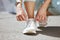 Shoes, feet and woman running in the street for fitness, cardio and marathon training in the city of Toronto. Shoelace