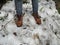 Shoes and footprints on the white snow. Trekking in the winters.