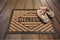 Shoes on new welcome doormat on wooden floor