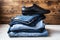 Shoes on a pile of jeans on a wooden background