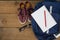 Shoes, spectacles, book, pencil, digital tablet and schoolbag on wooden table