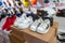 Shoes of various brands stands in a shoe market shop