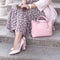 Shoes on women`s leg. pink shoes, bag. Sunglasses in the hands woman. Fashion ladies accessories, bracelets, eyeglasses.