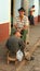 Shoeshine aan cleaning shoes on sidewalk