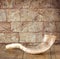 Shofar (horn) on wooden table. rosh hashanah (jewish holiday) concept . traditional holiday symbol.