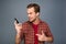 Shoked young man holding phone and reading message