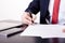 Shoot of financial director\'s hands signing business contract at the desk in his office.