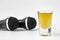 A shoot glass with liquor and two karaoke microphones on a white background