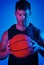 Shoot your shot. Blue filtered shot of a sportsman posing with a basketball in the studio.