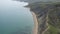 Shooting from air. Serene seascape. Pacific blue sea merges with sky on horizon