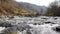 Shooting along a mountain river running over stones.