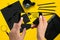 Shooting black stationery on phone`s camera. Stationery on yellow background.