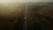 Shooting from a drone. a quadcopter flies from above through the clouds and shoots the sunset, trees, road with cars