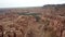 Shooting from a drone, top view of Charyn canyon. Red canyon, Martian view. Sandy and stone edge of the canyon