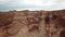 Shooting from a drone, top view of Charyn canyon. Red canyon, Martian view. Sandy and stone edge of the canyon