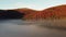 Shooting fog over the forest in the mountains. Dawn in the highlands. Aerial