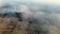 Shooting fog over the forest in the mountains. Dawn in the highlands. Aerial