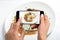 Shooting food on phone`s camera, Fried eggs on a white plate with mushroom on a white table, Food Photographer.