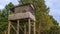 A shooting and observation tower for hunting in the forest at dusk. Active leisure concept
