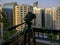 Shooting a time lapse of the sunset in a balcony in the city - camera and tripod