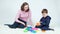 Shooting of woman and boy playing assembling pyramid