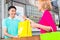 Shop assistant handing purchase to woman