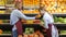 Shop clerk at grocery shelf checking products