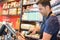 Shop clerk scanning bottle alcohol