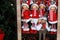 Shop window with Christmas and New Year`s toys and decorations. Funny dolls in santa claus hats on a shelf of a toy store.