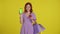Shopaholic woman with shopping bags holding credit card and showing smartphone green screen. Woman in the studio on a