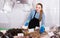 Shopgirl with apron offering fresh fish in shop