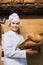 Shopgirl working in bakery with different pastry