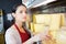 Shopkeeper arranging chunks cheese on shelf