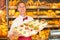 Shopkeeper in baker\'s shop with tray of sandwiches