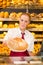 Shopkeeper in Bakery giving bread to customer