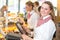 Shopkeeper at bakery working at cash register