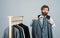 Shopper hipster man in fitting room menswear store, try on a suit concept