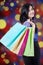 Shopper holds shopping bags with defocused background