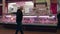 Shopper looking at the chilled food display of a Butchers inside an indoor market