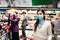 Shopper with mask safely buying for groceries due to coronavirus pandemic in grocery store.COVID-19 shopping.Quarantine