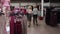Shopper women selecting clothes in clothing shop