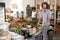 Shoppers Buying Fresh Fruit And Vegetables In Sustainable Plastic Free Grocery Store