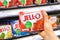 Shoppers hand holding a box of Jell-O brand strawberry gelatin dessert