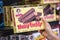 Shoppers hand holding a box of little Debbie Nutty Buddy brand crunchy wafer bars with peanut butter