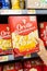 Shoppers hand holding a carton box of  Orville Redenbacher`s brand popcorn