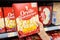 Shoppers hand holding a carton box of  Orville Redenbacher`s brand popcorn