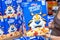 Shoppers hand holding a family size package of Kellogg`s brand Frosted Flakes cereal