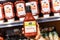 Shoppers hand holding a jar of 365 whole foods brand organic ketchup