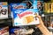 Shoppers hand holding a package of Twinkies brand golden sponge cakes with creamy filling