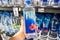 Shoppers hand holding a plastic bottle of Fiji brand natural artesian water
